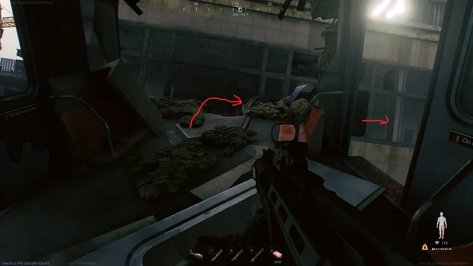 The inside of a tilted train car, with red arrows pointing the way through and out toward the building