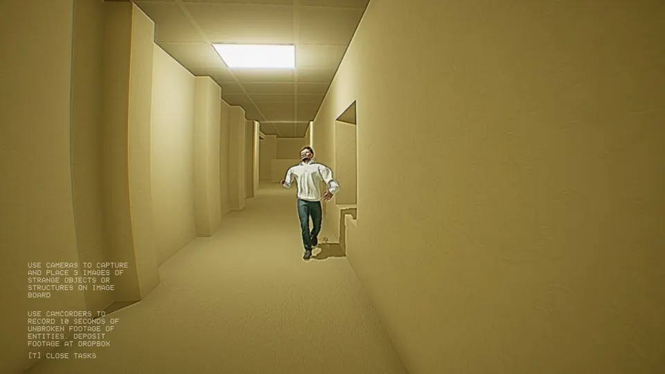 The average height being, a man in a white shirt and jeans, running along a lit yellow hallway