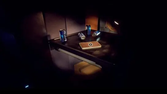 Soda cans and a journal on the table by the hole in the hull