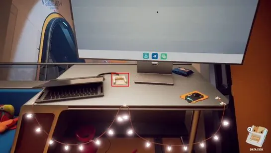 Rafael's laptop on the Lobby balcony desk with its disk slot outlined