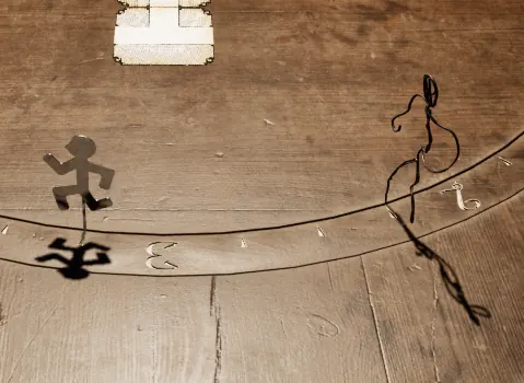 A close look at the clock track, with the group's shared player piece and the Visitor a few spaces apart on the same ring.