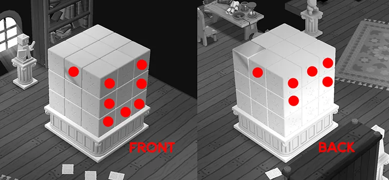 The sculptor's stone block from the front and from the back, with a red dot on every cube you need to bonk